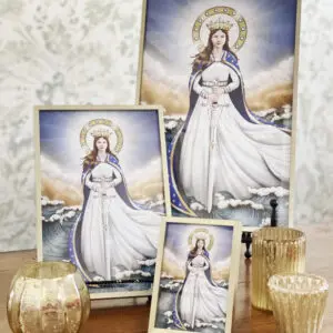 A table with three framed prints of the virgin mary.