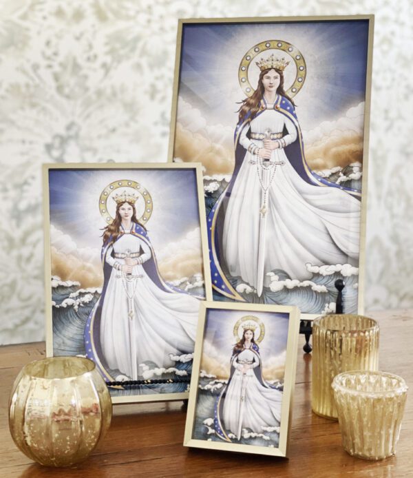 A table with three framed prints of the virgin mary.